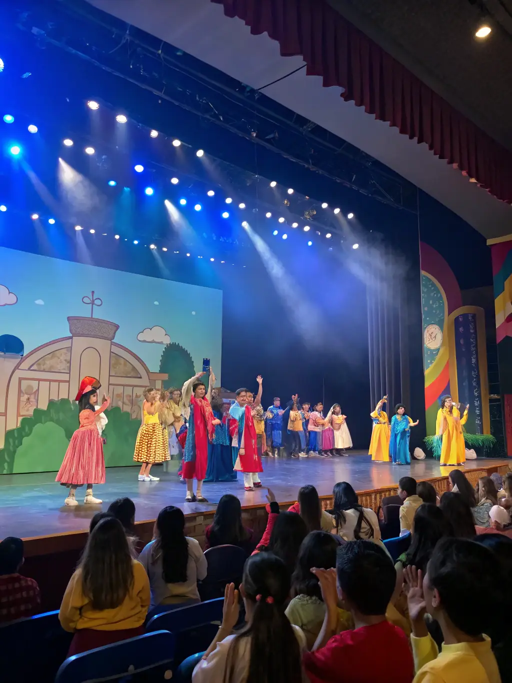 A dynamic image of a children's theater performance, showcasing young actors dressed in costumes and performing on a makeshift stage in a community center.